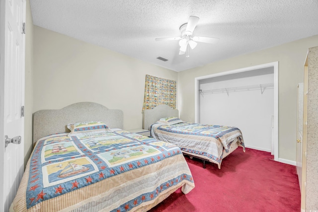 bedroom with a textured ceiling, a closet, ceiling fan, and carpet flooring