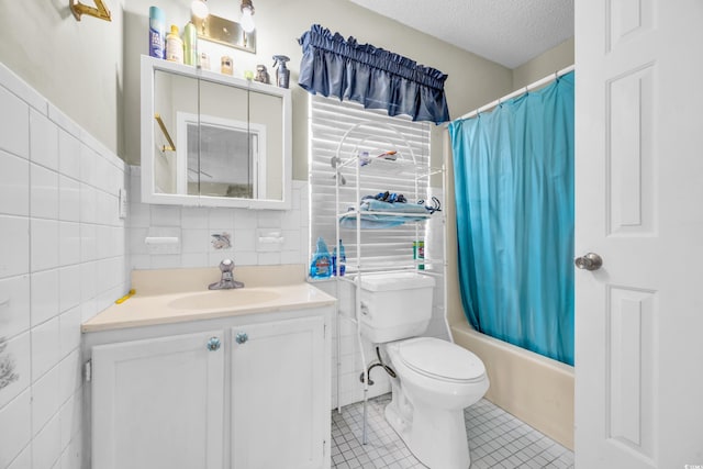 412 Chesterfield Ct, Myrtle Beach, SC 29577 - bathroom with tile walls, vanity, tile patterned floors, and a textured ceiling