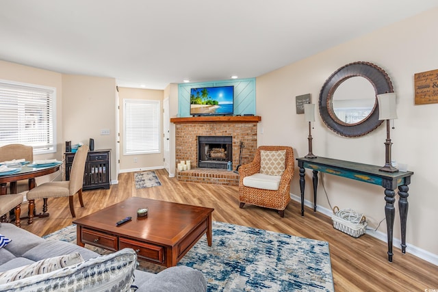 living room with hardwood / wood-style floors and a fireplace