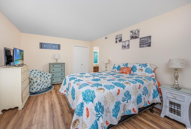 bedroom featuring hardwood / wood-style flooring and a closet