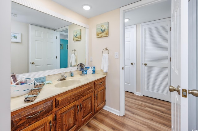 bathroom featuring hardwood / wood-style flooring and vanity