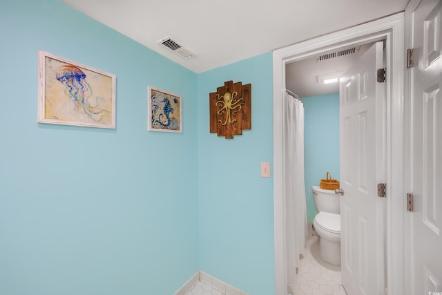 bathroom with tile patterned floors and toilet