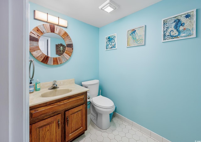 bathroom featuring vanity, toilet, and tile patterned flooring