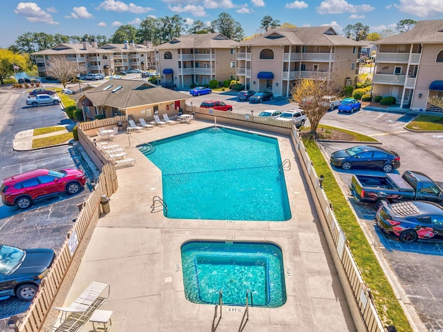 view of pool with a jacuzzi and a patio area