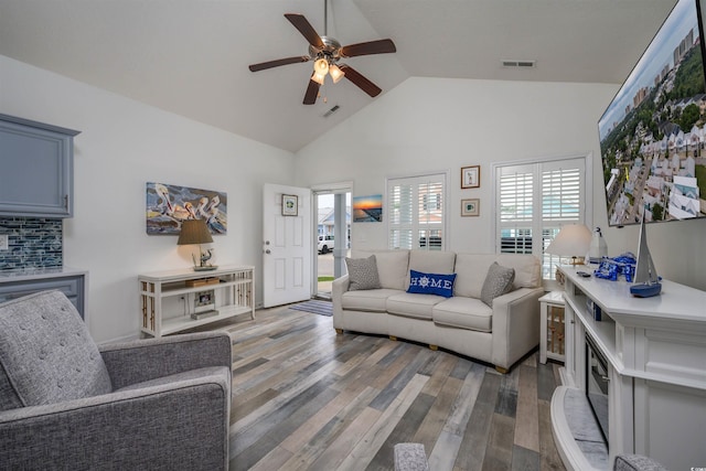 living room with high vaulted ceiling, hardwood / wood-style floors, and ceiling fan