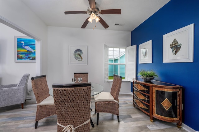 dining area featuring ceiling fan and light wood-type flooring