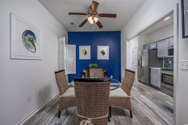 dining area featuring ceiling fan and light wood-type flooring