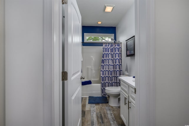 full bathroom with shower / tub combo with curtain, vanity, hardwood / wood-style floors, and toilet