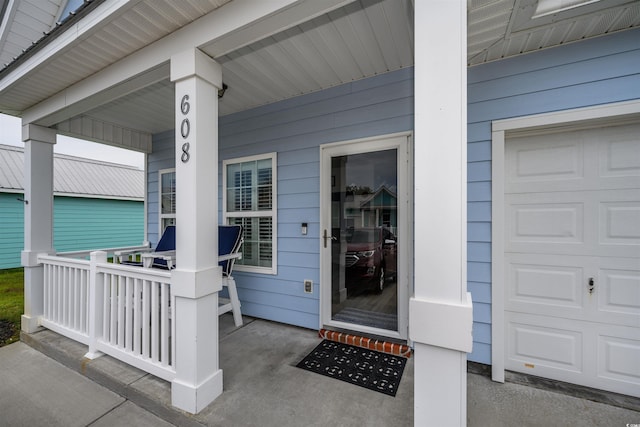 property entrance featuring a garage and covered porch