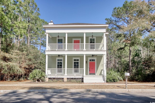 greek revival house with a porch, a chimney, and a ceiling fan