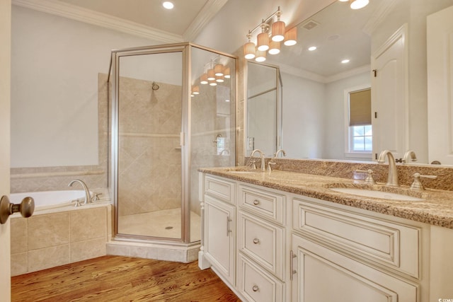 bathroom with a shower stall, ornamental molding, wood finished floors, and a sink