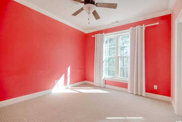 unfurnished room with visible vents, baseboards, ceiling fan, crown molding, and carpet flooring