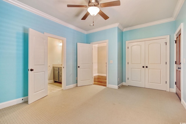 unfurnished bedroom featuring baseboards, light colored carpet, a closet, and ornamental molding