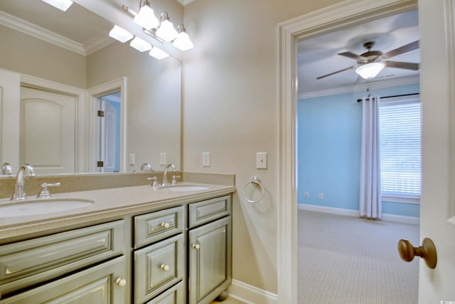 bathroom featuring a sink, baseboards, and crown molding