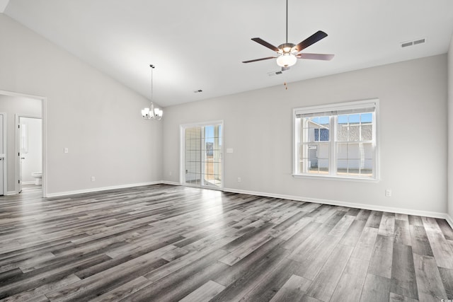 unfurnished living room with dark wood-type flooring, lofted ceiling, and ceiling fan with notable chandelier