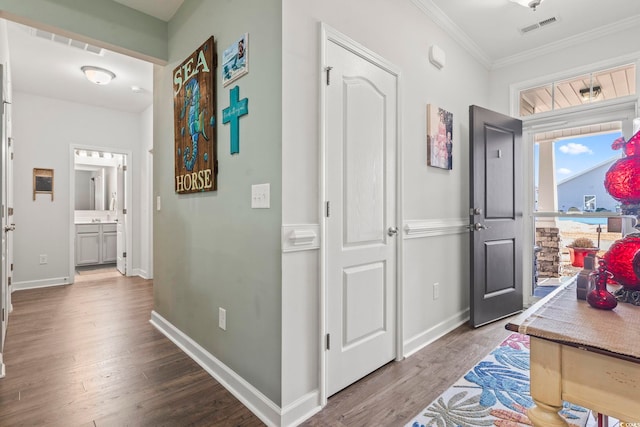 hall featuring hardwood / wood-style flooring and crown molding