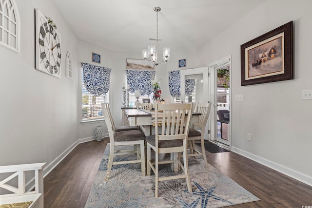 dining area featuring dark hardwood / wood-style floors and a chandelier