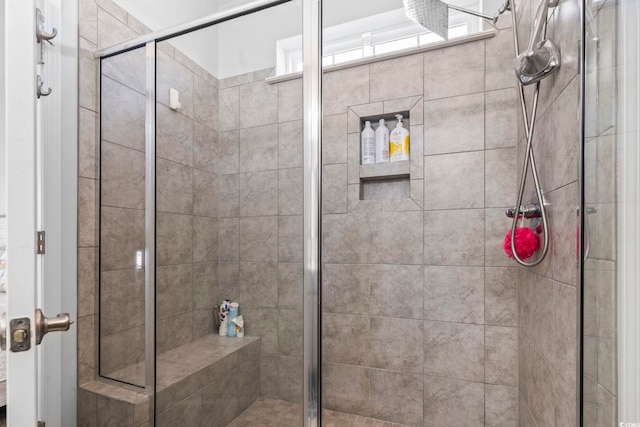 bathroom featuring a shower with door