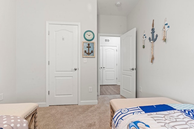 bedroom featuring light carpet