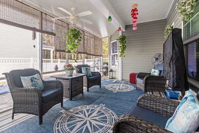 sunroom featuring beamed ceiling and ceiling fan