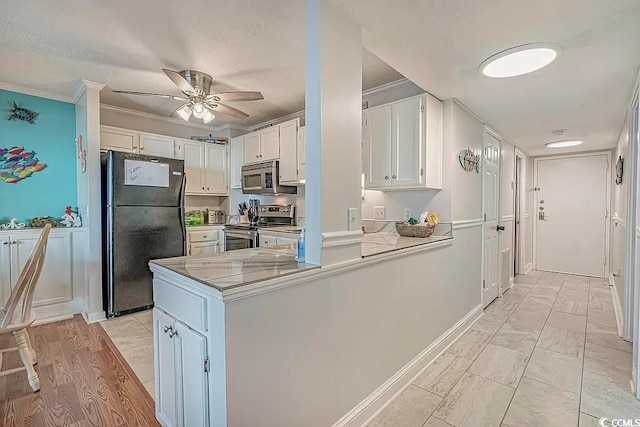 kitchen with crown molding, kitchen peninsula, white cabinets, and appliances with stainless steel finishes