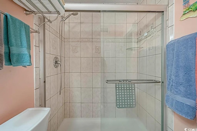 bathroom featuring a shower with door