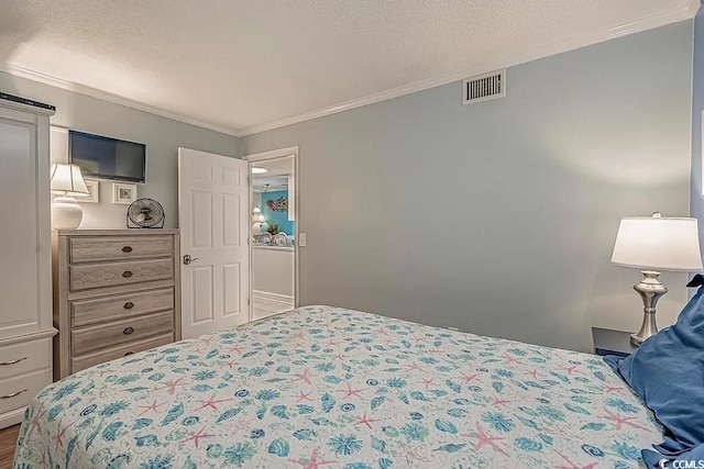 bedroom featuring crown molding and a textured ceiling