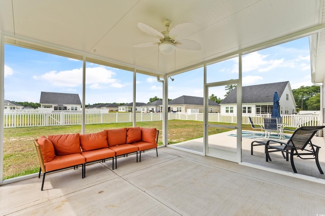 sunroom / solarium with plenty of natural light and ceiling fan