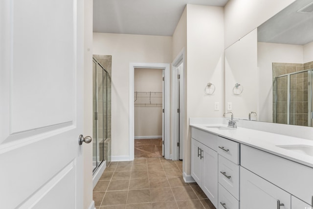 bathroom featuring walk in shower, vanity, and tile patterned flooring