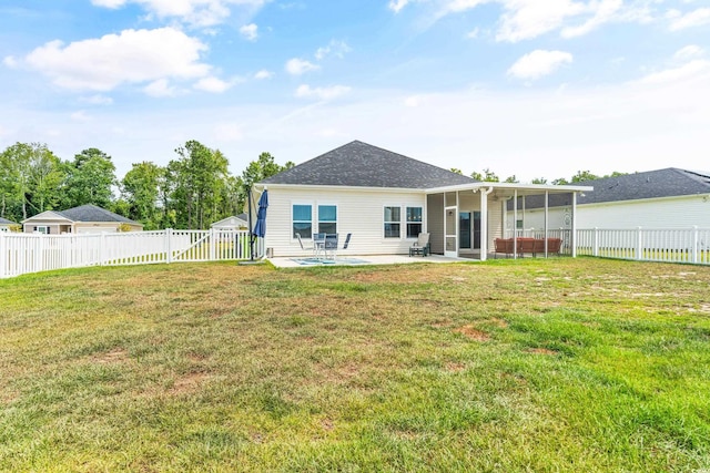 rear view of property featuring a patio and a lawn