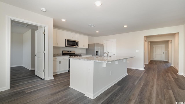 3489 Ashridge Way, Conway, SC 29526 - kitchen with appliances with stainless steel finishes, white cabinetry, sink, dark hardwood / wood-style flooring, and a center island with sink