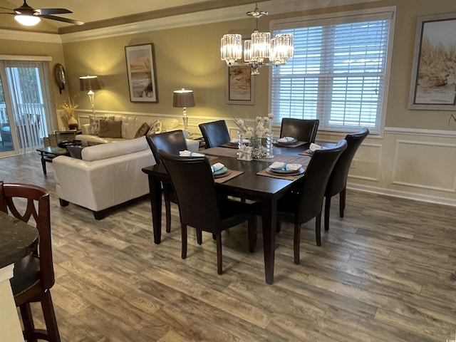 dining room featuring ornamental molding, wood-type flooring, and a healthy amount of sunlight