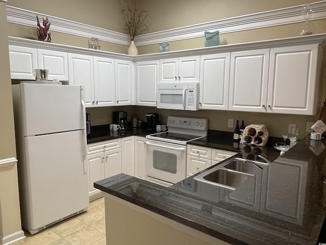 kitchen with white cabinetry and white appliances