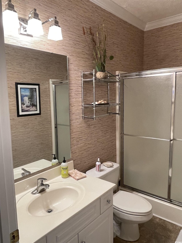 bathroom featuring toilet, an enclosed shower, ornamental molding, vanity, and tile patterned flooring