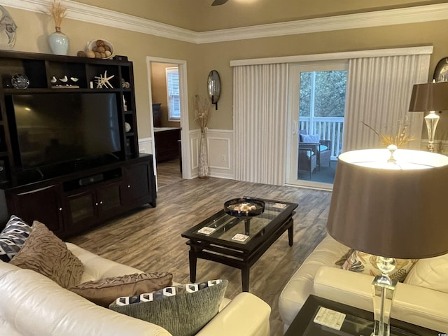 living room with hardwood / wood-style floors, crown molding, and ceiling fan