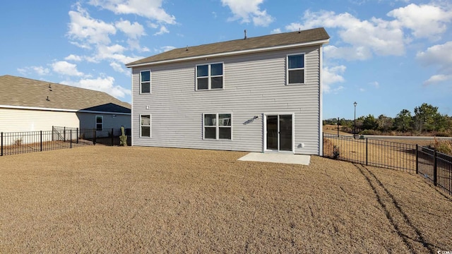 rear view of property with a yard and a patio area