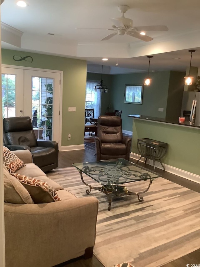 living room with wood-type flooring and ceiling fan