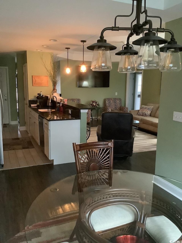 dining area featuring sink and hardwood / wood-style floors