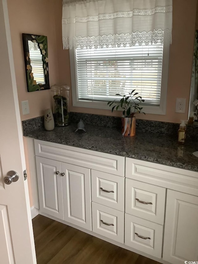 interior space featuring vanity and hardwood / wood-style flooring