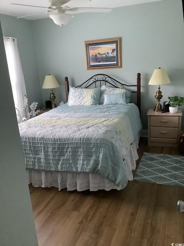 bedroom featuring dark hardwood / wood-style floors and ceiling fan