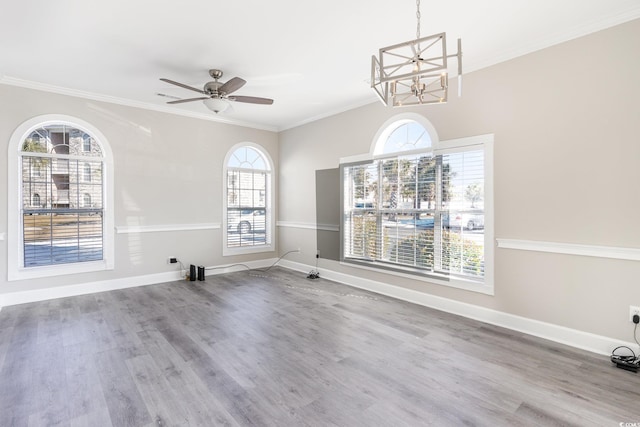 interior space with crown molding, hardwood / wood-style flooring, and ceiling fan with notable chandelier