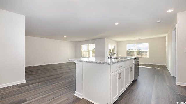 kitchen featuring sink, a center island with sink, white cabinets, and dark hardwood / wood-style floors
