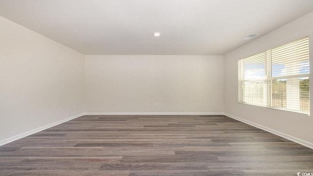 spare room featuring dark hardwood / wood-style flooring