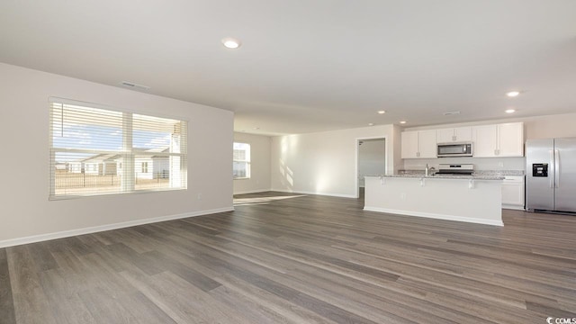 unfurnished living room featuring dark hardwood / wood-style flooring