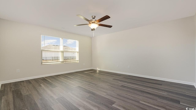 spare room featuring ceiling fan and dark hardwood / wood-style floors