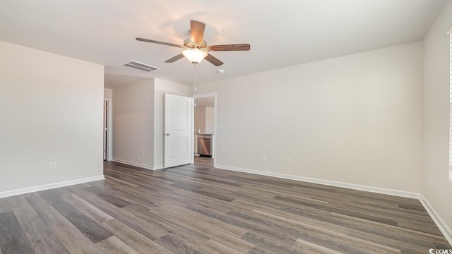 empty room with ceiling fan and dark hardwood / wood-style flooring