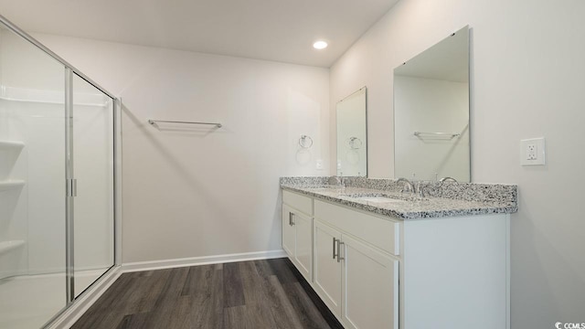 bathroom with a shower with door, wood-type flooring, and vanity