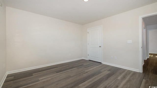 spare room featuring dark wood-type flooring