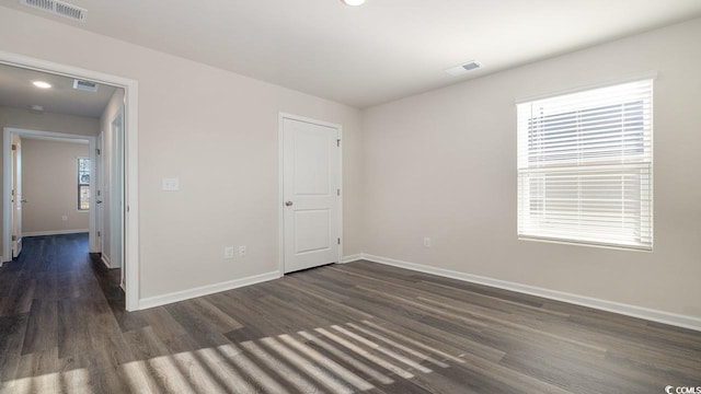 spare room with dark hardwood / wood-style flooring