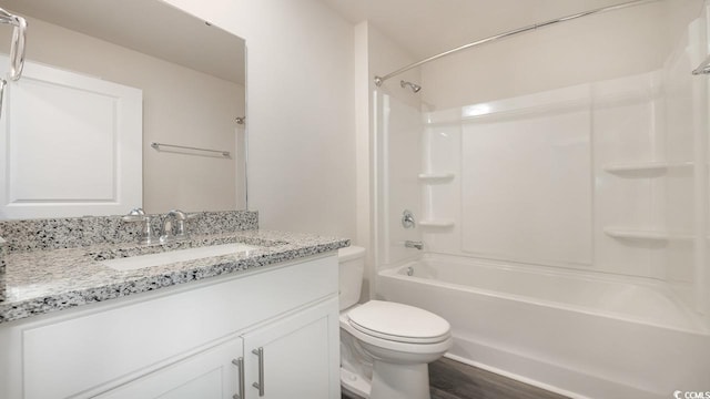 full bathroom with hardwood / wood-style flooring, vanity, toilet, and shower / bath combination